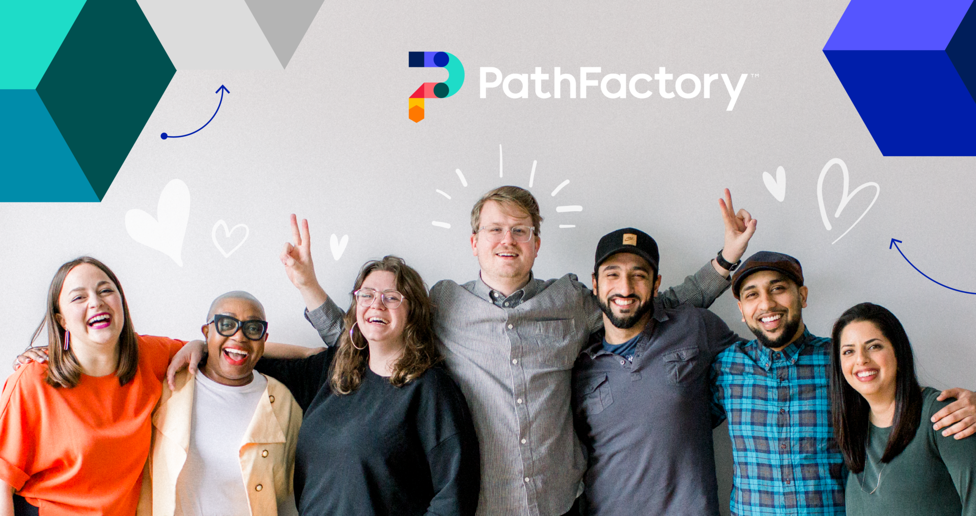 Header Image showing a ground of 7 people from the PathFactory Team smiling at at the camera. Above the group is PathFactory's logo and some colourful shapes on a light grey background.