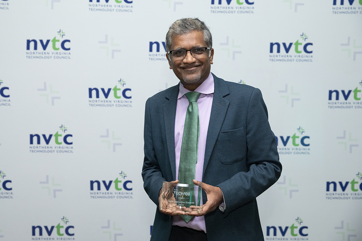 Photo of Dev Ganesan, CEO of PathFactory holding a NVTC Tech 100 award