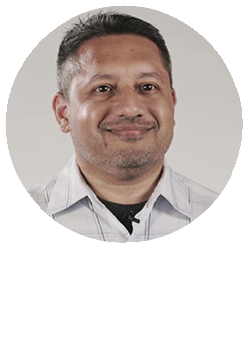 Circular Headshot of Mervyn Alamgir on top of the white Tibco logo