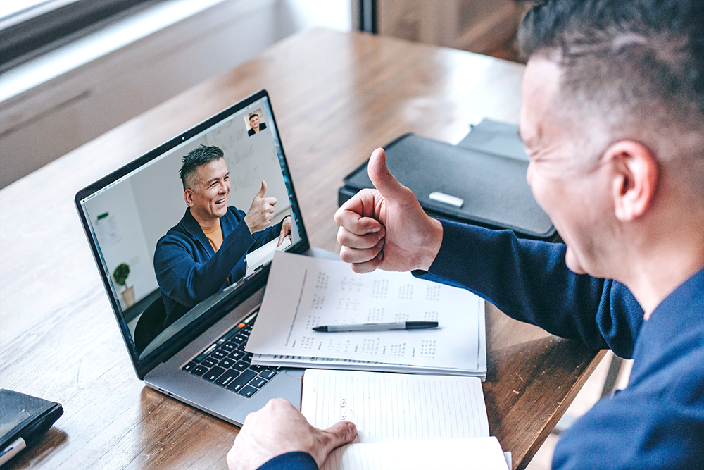 A marketer congratulating himself with a thumbs up on a zoom call with himself for vanity metrics